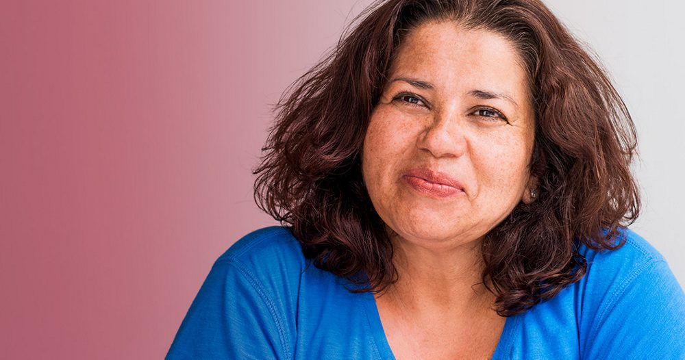 A middle-aged menopausal  women looking confident and smiling