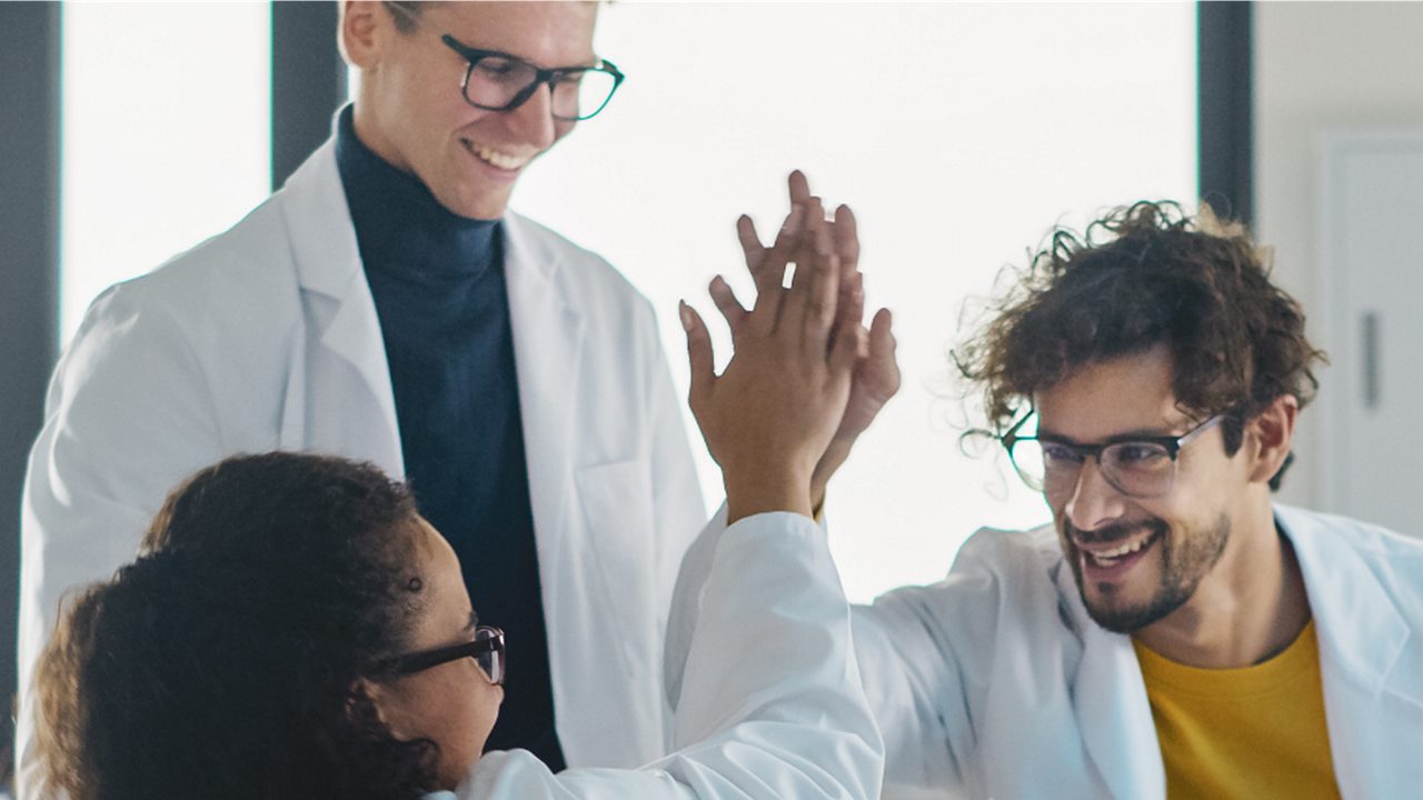 A group of scientists in partnership, showing Astellas’ focus to advance medical science knowledge.