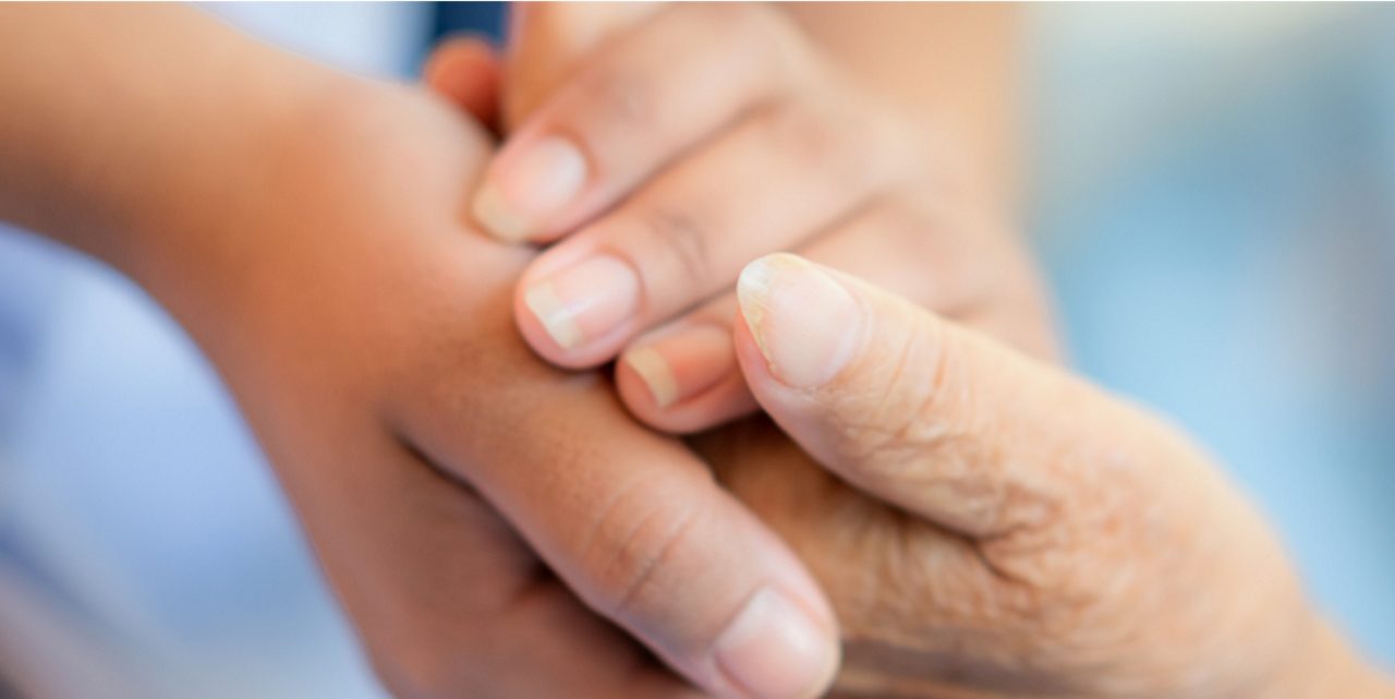 Family members clasp hands, illustrating Astellas’ support for patients and their families.