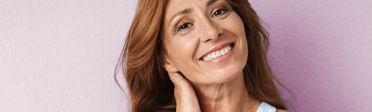 Woman at shop door smiling