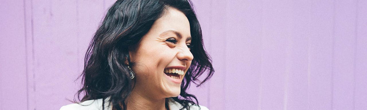 Woman at shop door smiling