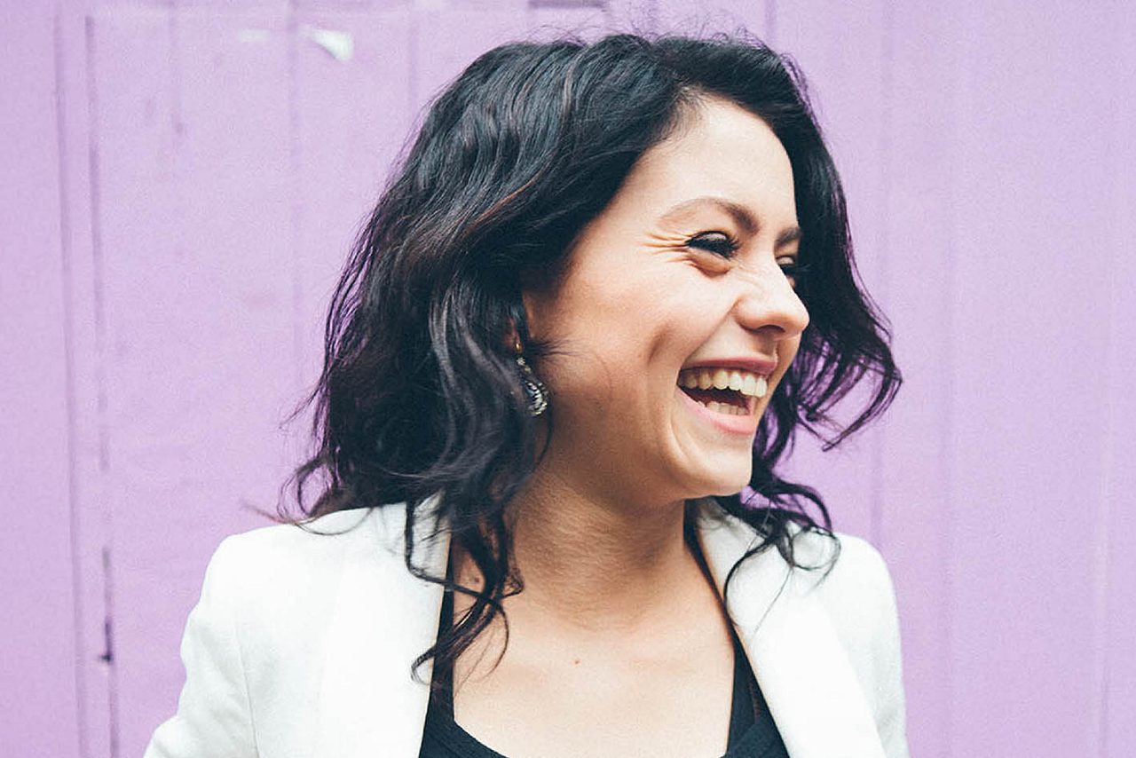 Woman at shop door smiling