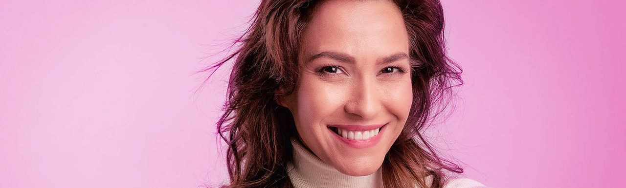 Woman at shop door smiling
