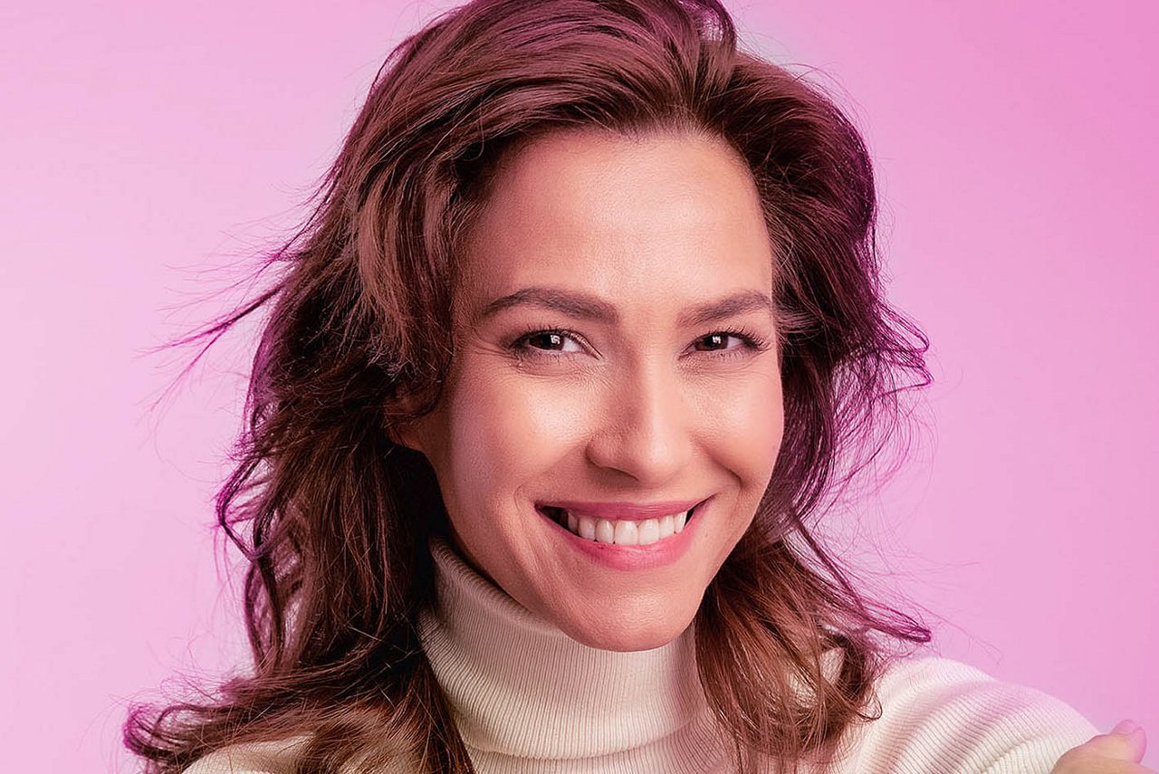 Woman at shop door smiling