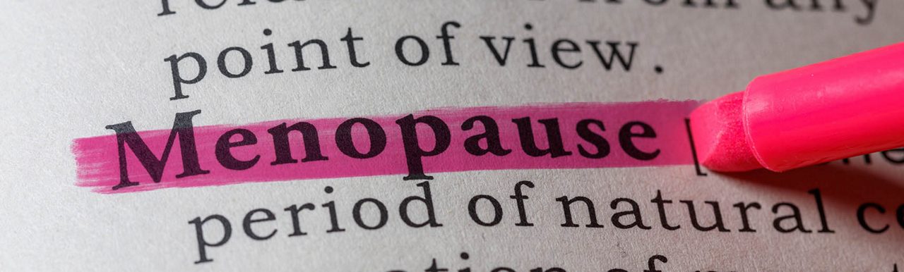 Woman at shop door smiling