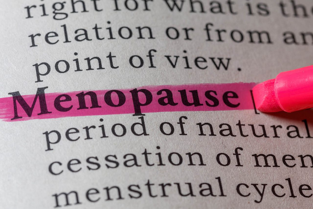 Woman at shop door smiling