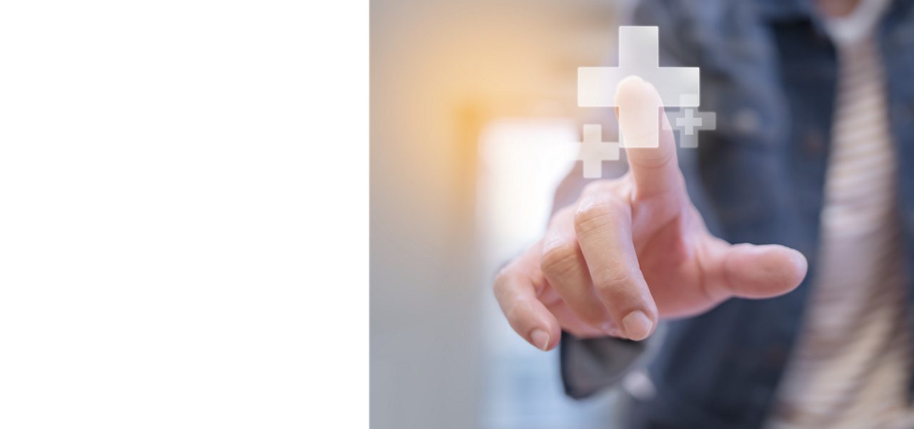 A man touches a digital screen showing a positive symbol, illustrating Astellas’ agile digital focus. 