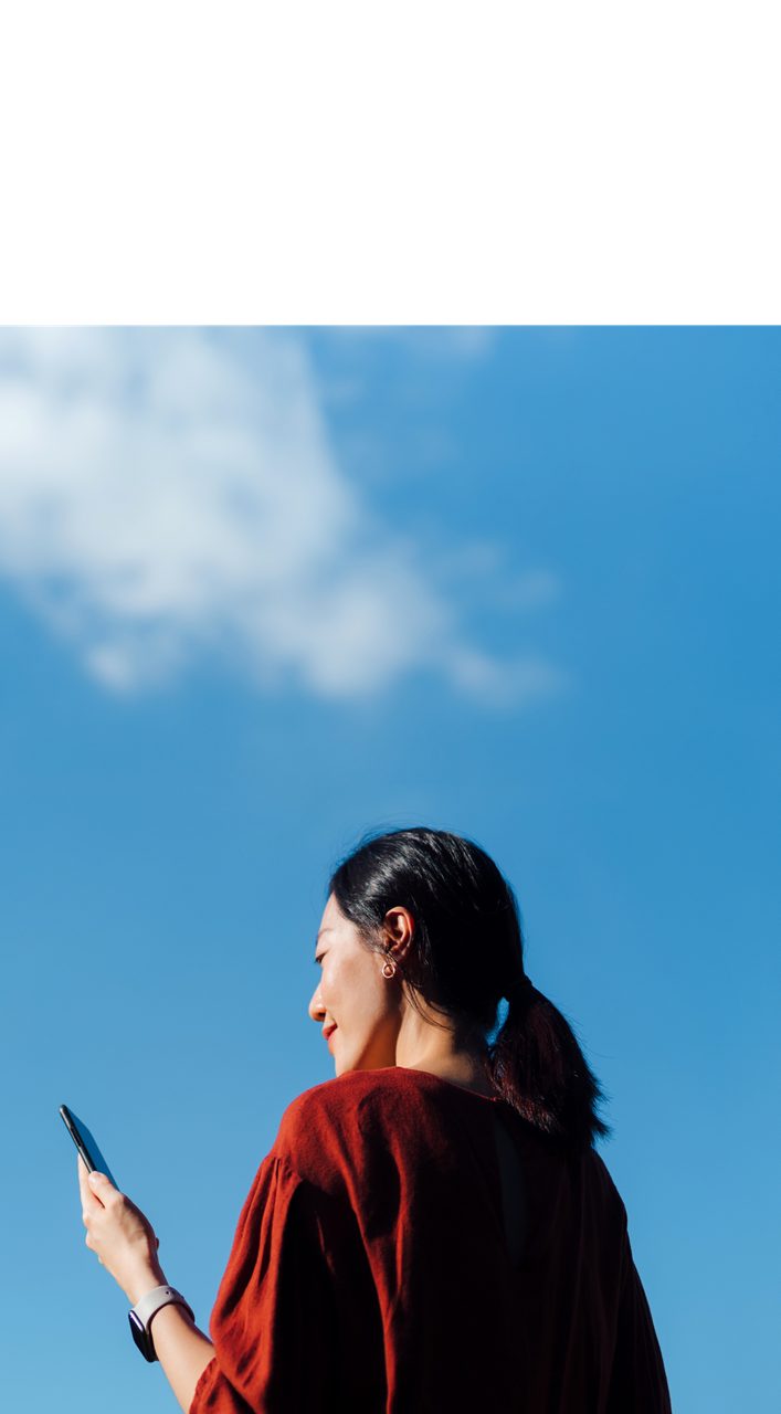An Astellas employee holding a phone, reflecting on the company’s aim to be an Employer of Choice.