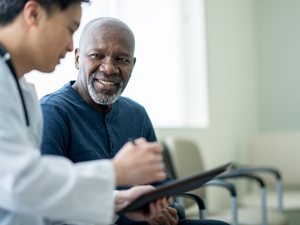 A doctor speaks to a patient, reflecting Astellas’ commitment to tackling today’s most challenging cancers.