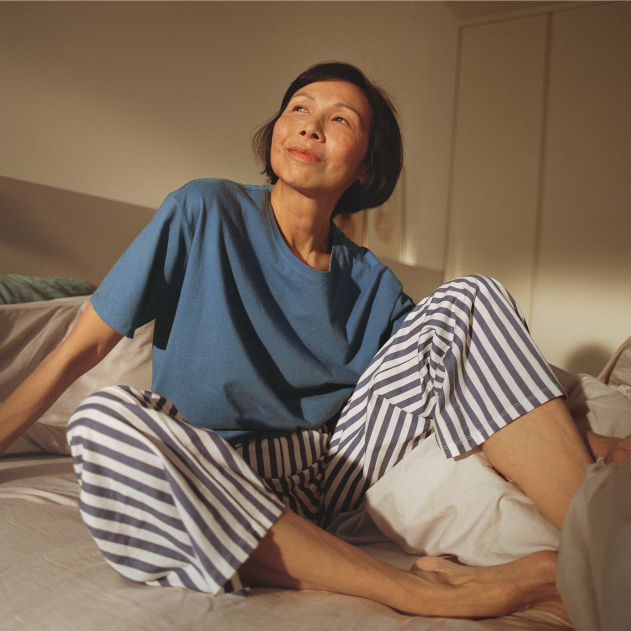 A woman contemplates VMS, which is why Astellas invests in research to better understand how stigma is impacting menopause care.