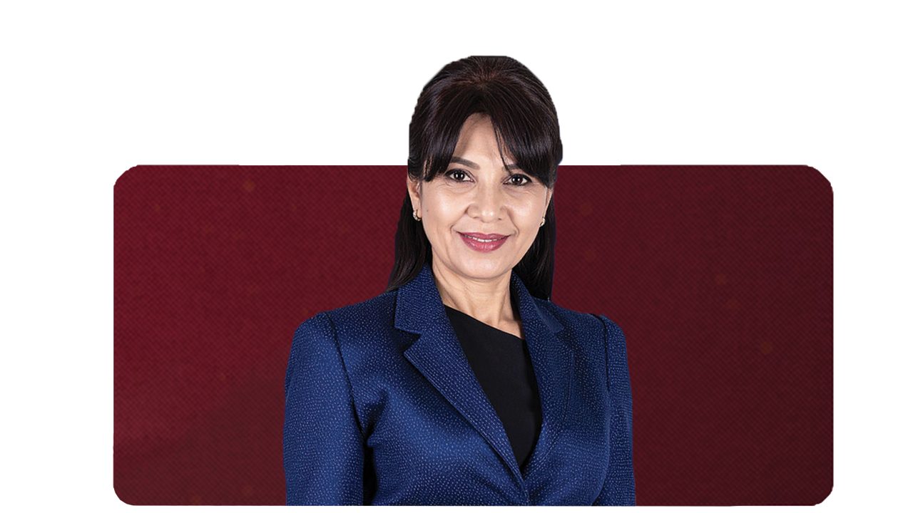 Middle-aged menopausal Hispanic woman looking down, with light reflecting on her perspiration.