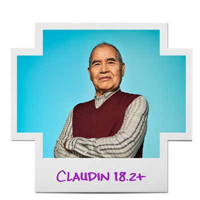 Man in maroon sweater vest inside a Claudin 18.2-positive frame.