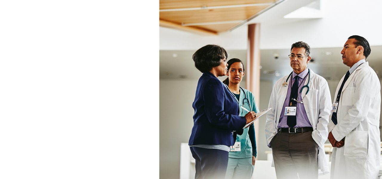 A group of healthcare professionals in discussion, reflecting Astellas’ commitment to supporting HCPs with clinical trial resources and patient-focused tools.