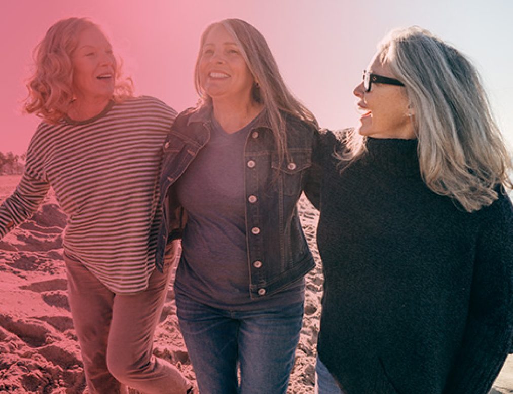 Middle-aged menopausal woman on the beach looking happy