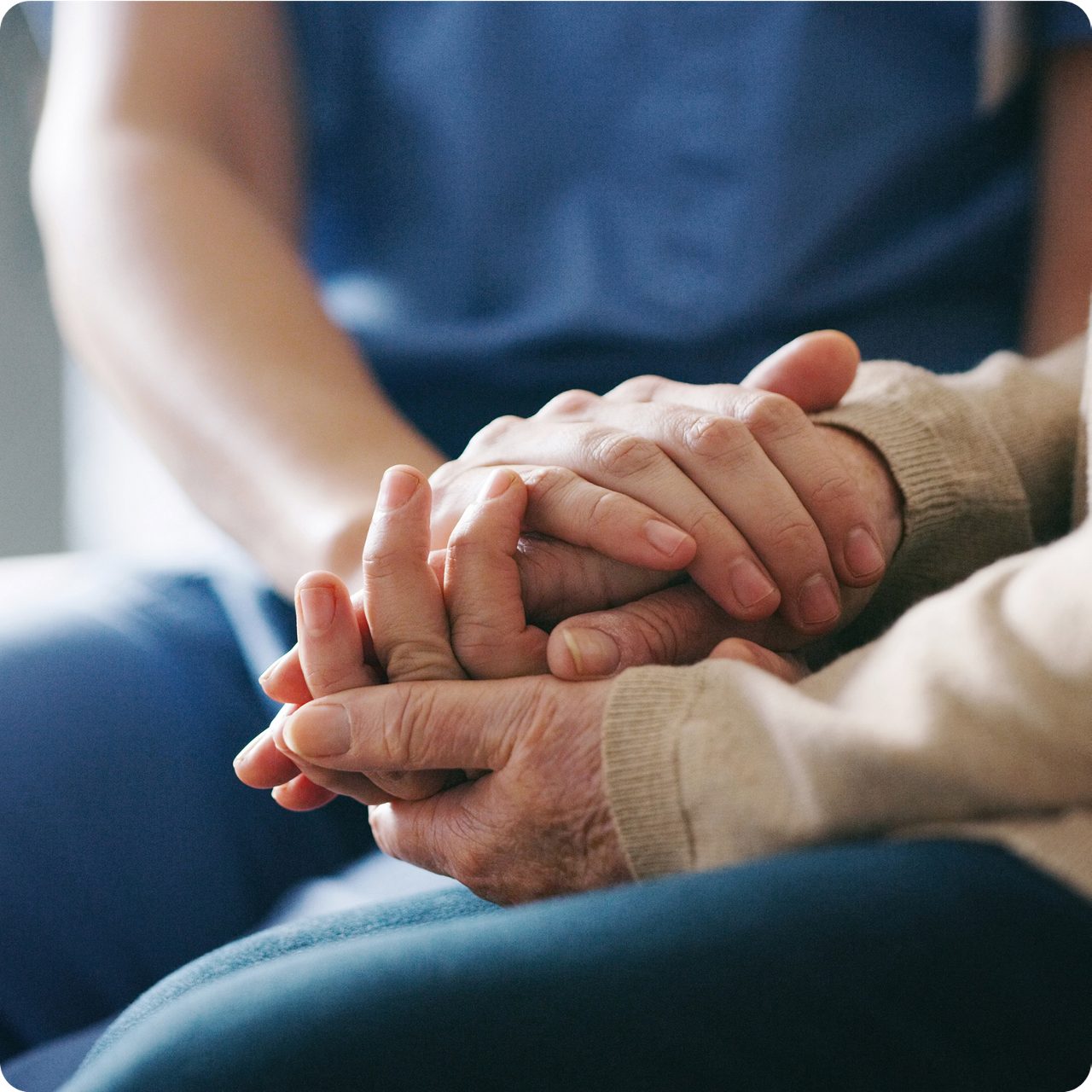 Hands held in a quiet moment of care, echoing Astellas’  focus on improving lives through patient-centered  innovation.