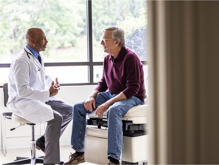  A patient consults his doctor during transplant care, supported by Astellas' immunology treatments for long-term success.