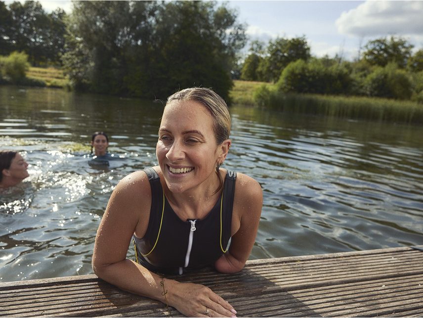  A woman smiles while outdoors, reflecting Astellas’ innovation in women’s health and menopause care.