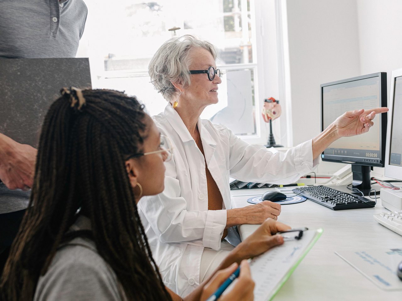 Astellas scientists at a computer, illustrating the organization’s R&D strategy guided by a Focus Area Approach.