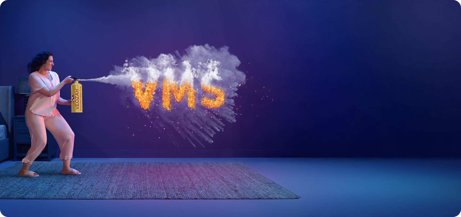  Woman spraying VEOZAH™ (fezolinetant) logo fire extinguisher at VMS fire in bedroom