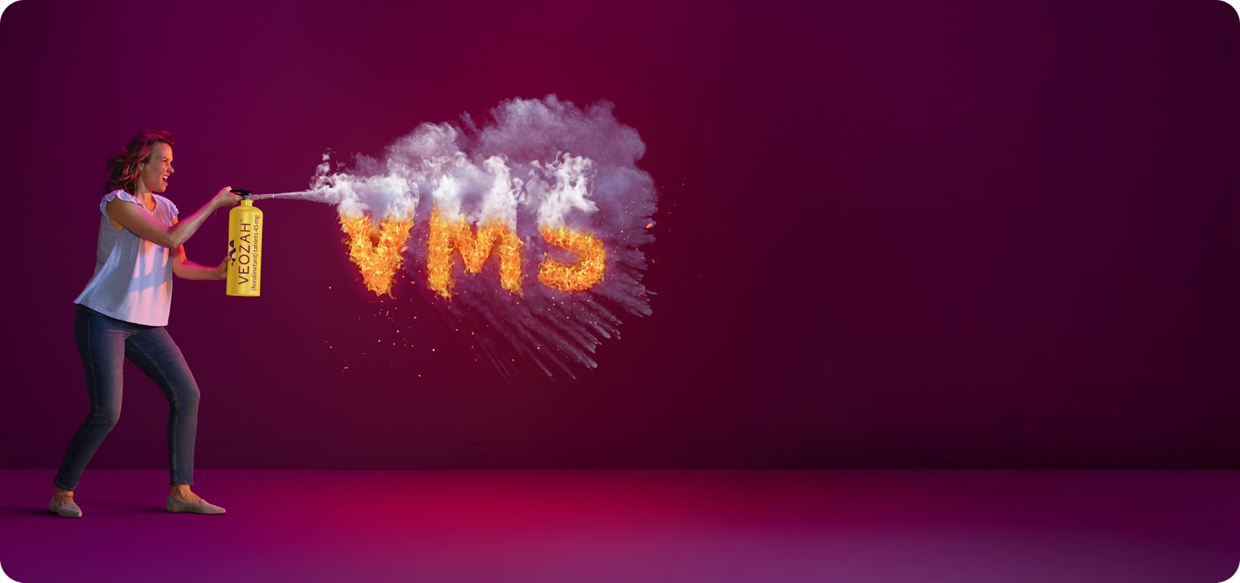  Woman spraying VEOZAH™ (fezolinetant) logo fire extinguisher at VMS fire