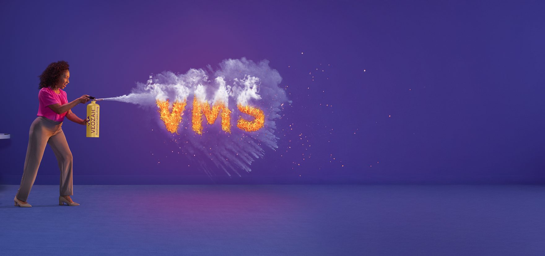  Woman spraying VEOZAH™ (fezolinetant) logo fire extinguisher in office