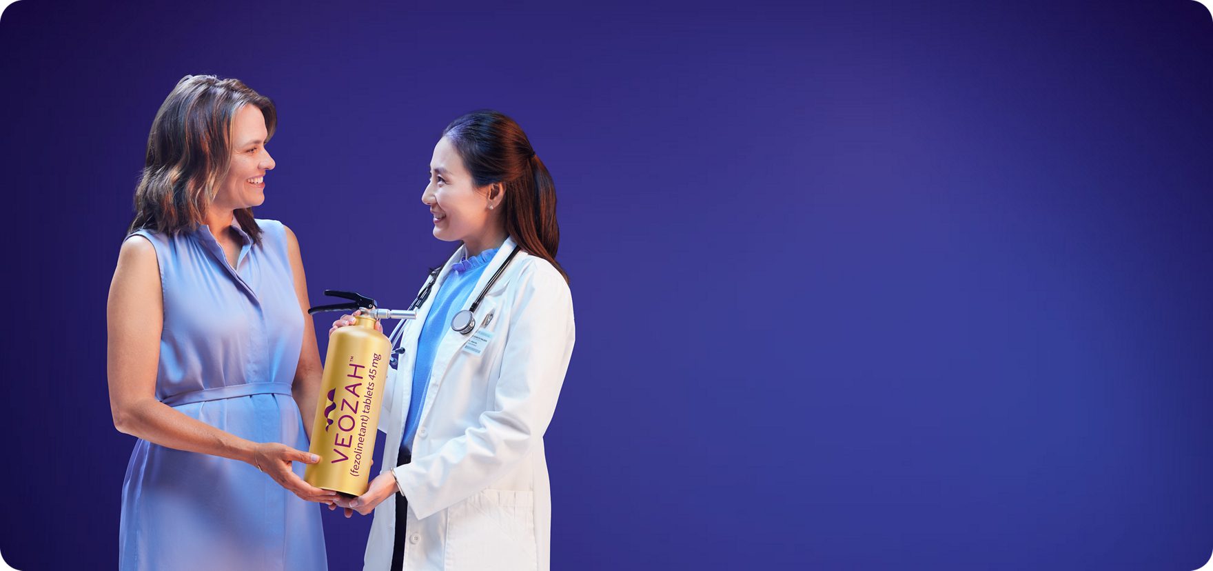  Woman and doctor holding VEOZAH™ (fezolinetant) logo fire extinguisher