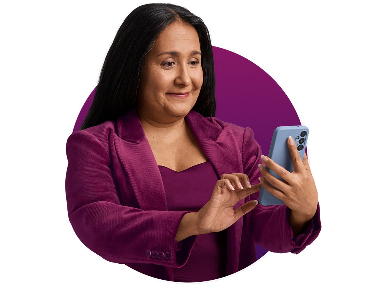 A woman holding a phone and smiling