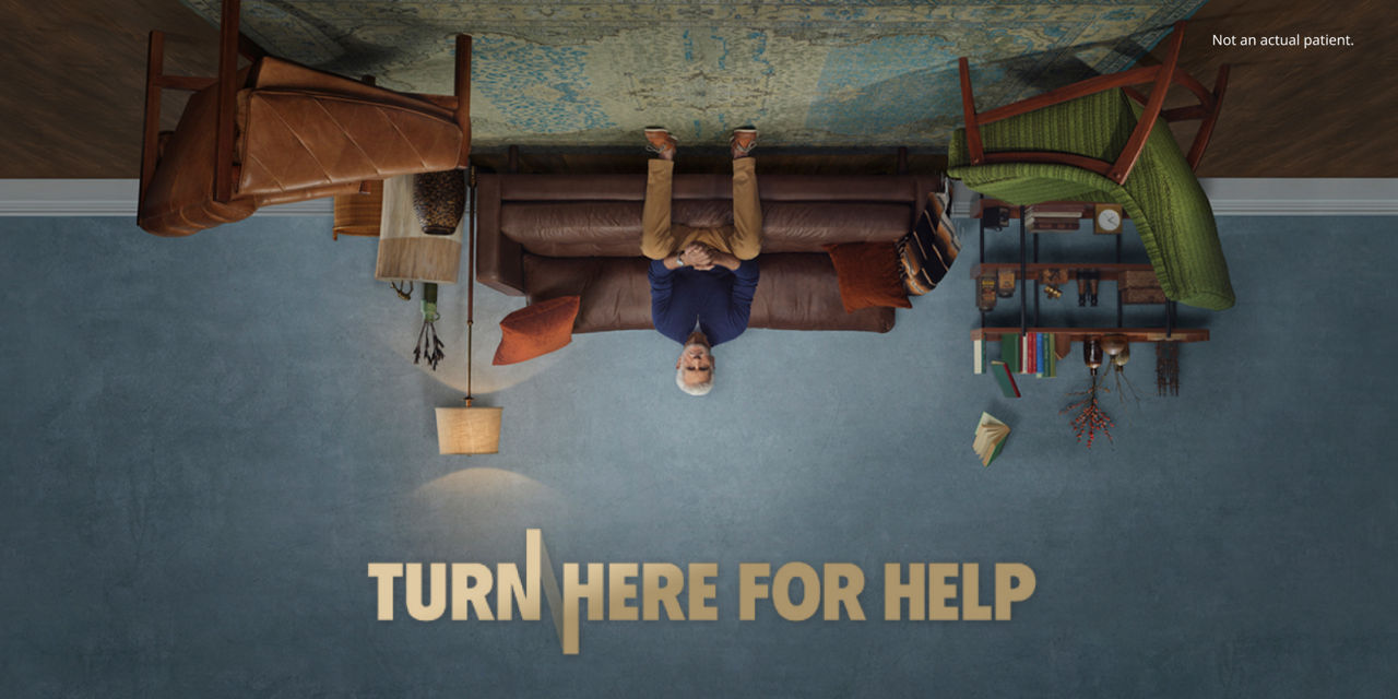 Upside down image of a man on a couch.