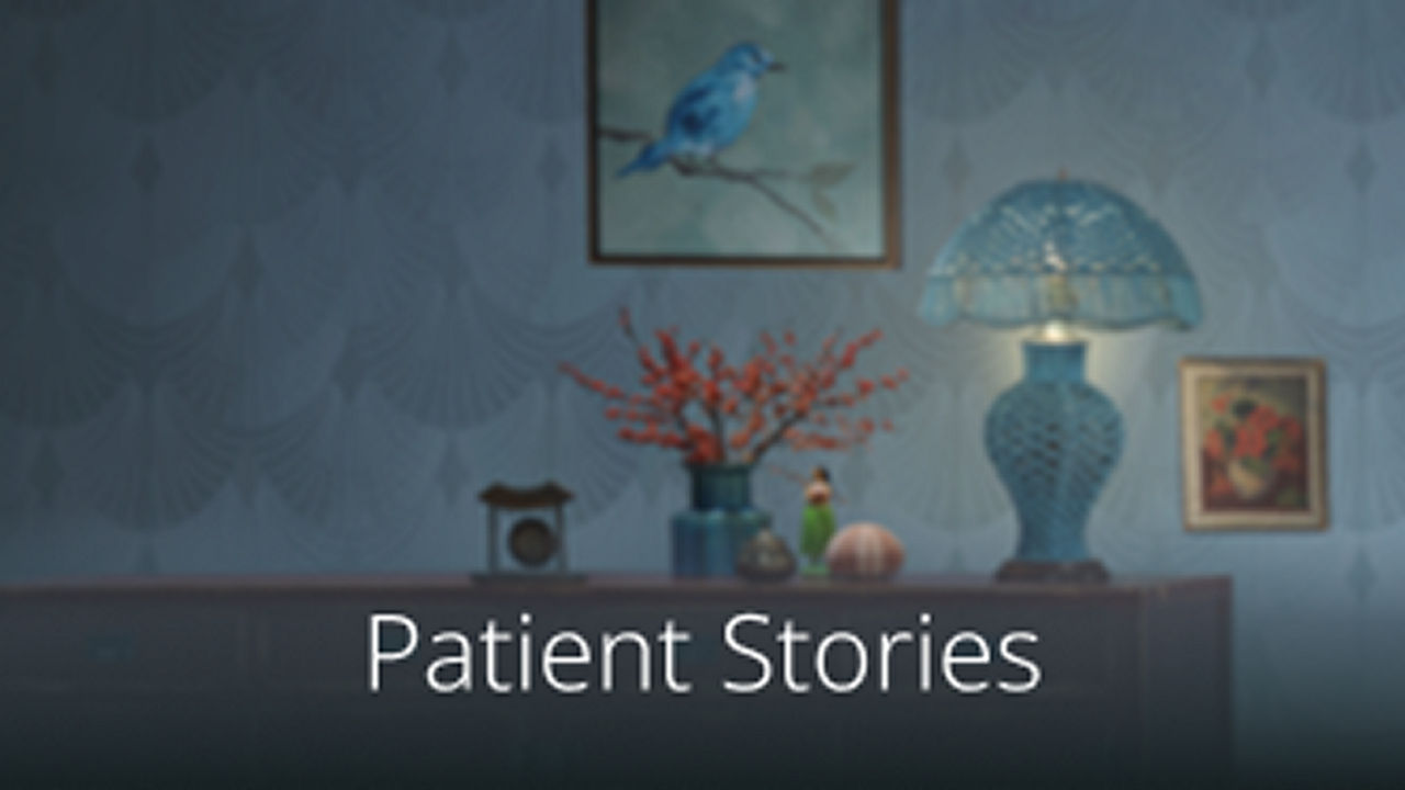 Shelf with lamp and flowers against a wall with two paintings.